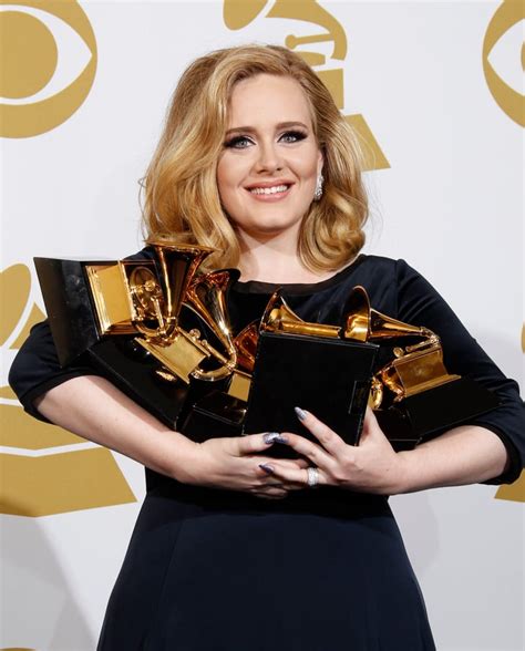 Adele held on to her Grammy Awards in the press room during the 2012 ...