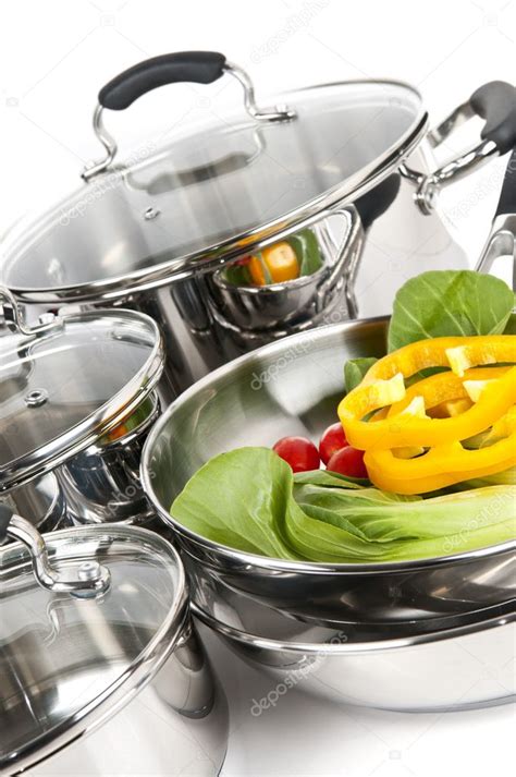 Stainless steel pots and pans with vegetables — Stock Photo © elenathewise #4518494