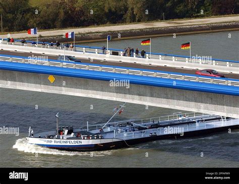 A barge sails on the Rhine river under the new Pierre Pfimlin bridge linking Eschau in France ...