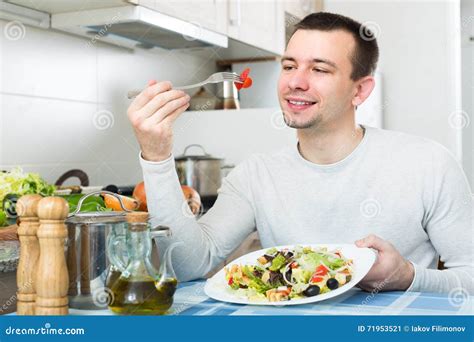 Man Eating Vegetable Salad in Kitchen Stock Image - Image of fork, organic: 71953521