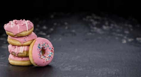 Premium Photo | Pink glazed donuts closeup shot