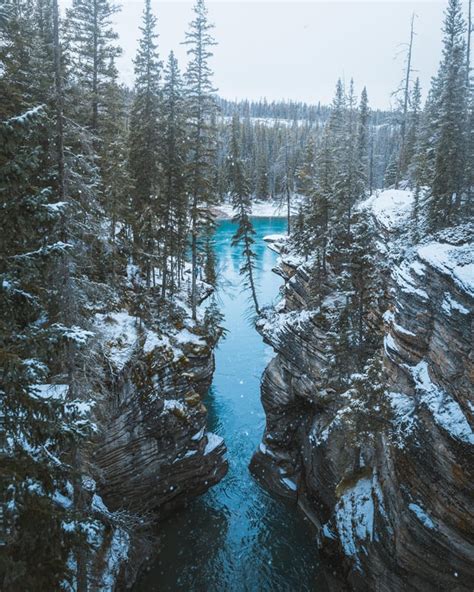 The beginning of winter at Athabasca Falls in Jasper National Park, Canada [OC](2496x3120) : r ...