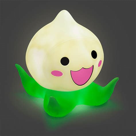 an illuminated toy with a smiling face and green leaves