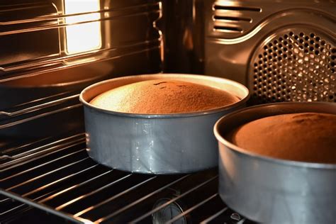 Premium Photo | Close up of baking chocolate cakes in the hot oven ...