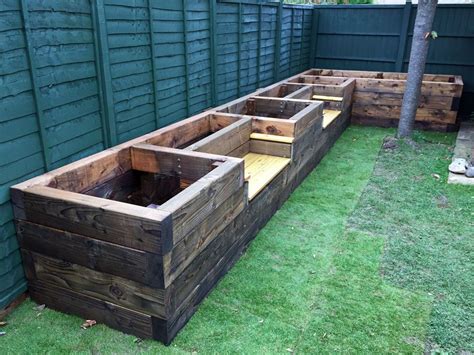 Les Mable's raised beds with bench seats from new railway sleepers. Railwaysleepers.com