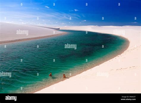 Brazil, Maranhao, Barreirinhas, Lencois Maranhenses National Park, river between the white sand ...