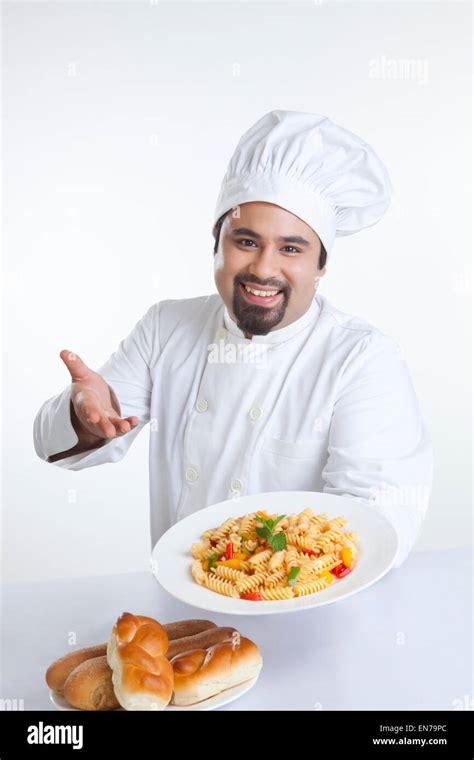 Portrait of chef with plate of pasta Stock Photo - Alamy