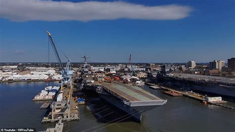 US Navy supercarrier USS John F. Kennedy catapults cars into river