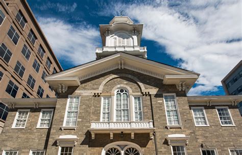 an old brick building with a clock tower on it's top and two windows