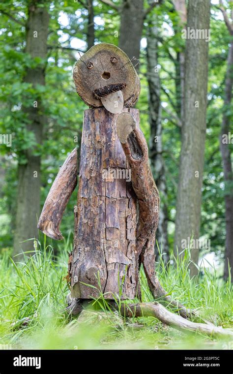 Funny figure made of wood stands in the woods Stock Photo - Alamy