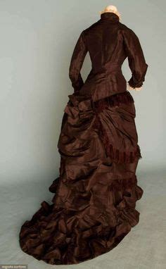 BROWN-BLACK BUSTLE GOWN, c. 1875 2-piece, Polonaise bodice & skirt trimmed w/ silk fringe & self ...