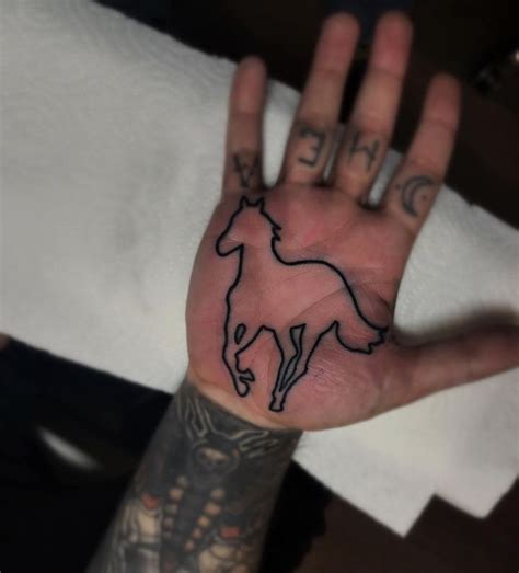 An outline Deftones logo inked on the right palm by Mark Walker An outline Deftones logo inked ...