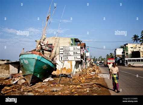 A boat sits where a shop used to, after the Tsunami that hit Sri Lanka ...