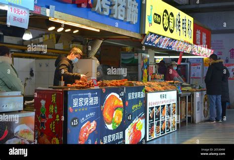 Street food market in Jiaxing, Zhejiang, China. Indoor stalls selling various fast food snacks ...