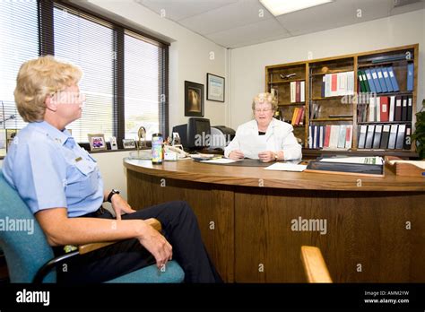 Female Captain talking to female prison Warden. Omaha Correctional Center, Omaha, Nebraska, USA ...