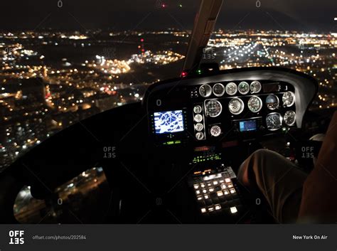 The cockpit of a helicopter in flight at night stock photo - OFFSET