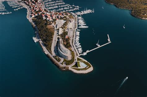 Aerial View of Boats Docked Along a Building on an Island · Free Stock ...