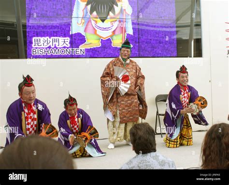 Japanese men clad in traditional Shinto priest costumes perform the "Mikawa-Goten-Manzai" ritual ...