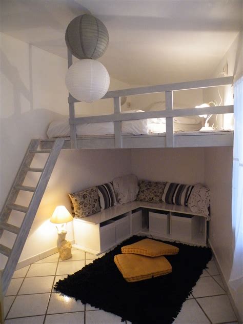 there is a loft bed with stairs to the second floor and a couch under it