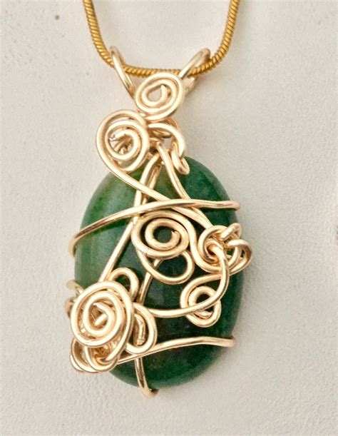 Beautiful gold wrapped Jade stone pendant necklace.