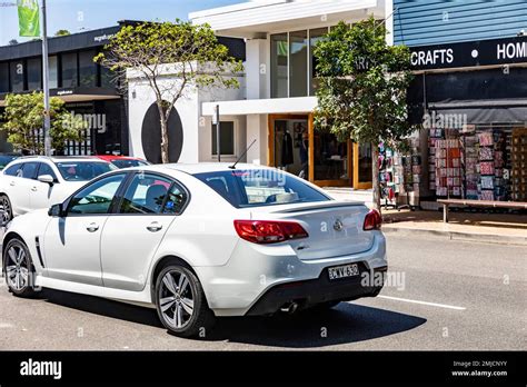 White Holden Commodore saloon car driving on the road in Sydney ...