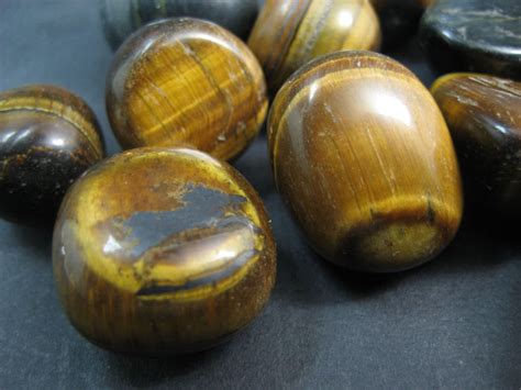 A natural Tigers Eye rock specimen together with 12 Tigers Eye polished pebbles - 98 x 64mm and ...