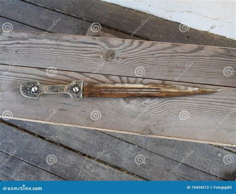 Sharp Cossack Saber With A Wooden Handle, Stuck In The Ground. Weapons ...