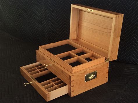 A photo showing the interior of a custom jewelry box. The trays and drawer are customized to ...