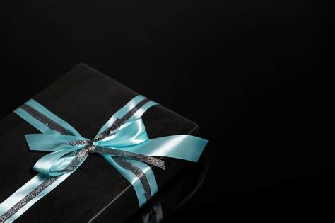 Premium Photo | Black gift box with a turquoise bow on a black surface ...