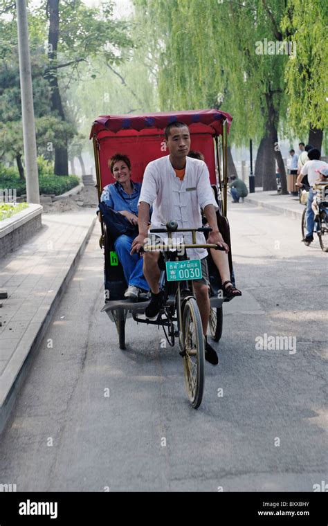 American tourist in foot powered tuk tuk in Beijing, China Stock Photo - Alamy