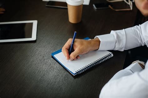 Premium Photo | Close-up of a guy writing in a notebook his ideas and thoughts