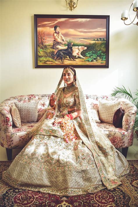 Photo of A regal Sikh bride in ivory lehenga on her wedding day.