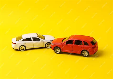 Premium Photo | Two mini toy car crash on a yellow background incident ...