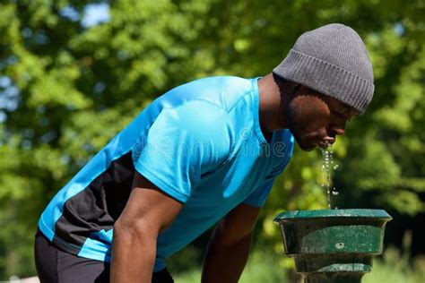 Young Man Drinking Water In A Fountain Stock Photo - Image of park ...