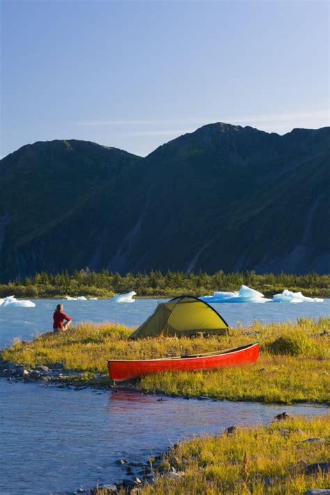 Woman Camping On An Island Via Canoe On Bear Glacier Lake, Kenai Fjords ...