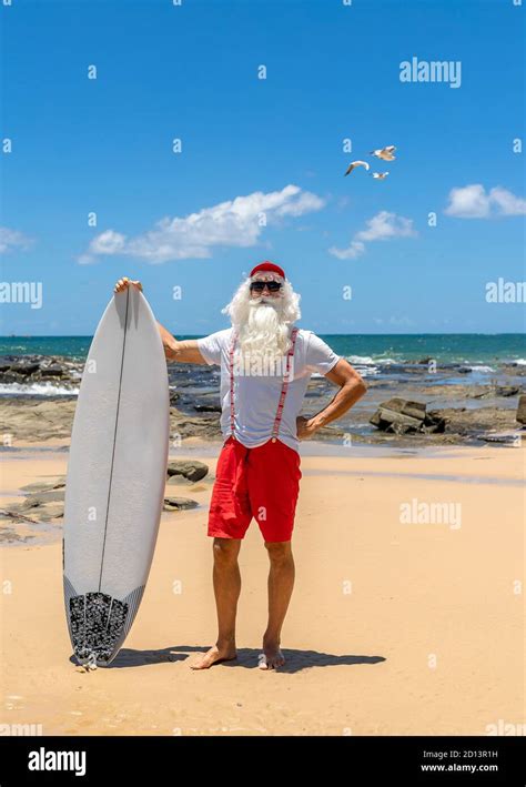 Santa Claus with a surf board with the ocean on backgraund. Australia ...