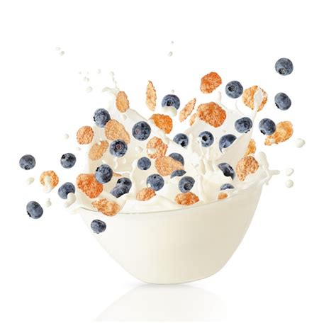 Premium Photo | Cereal corn flakes and blueberries falling into bowl ...