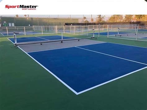 an outdoor tennis court with blue and green courts