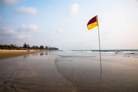 Red and Yellow Safety Flag on Long Sandy Beach Stock Image - Image of ...