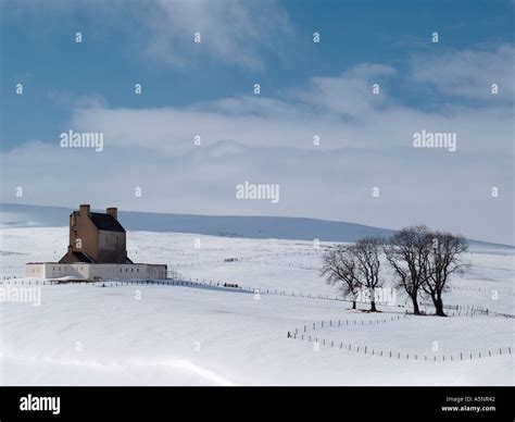 CORGARFF CASTLE 1550 in WINTER with snow on Grampian mountains Corgarff Aberdeenshire Scotland ...