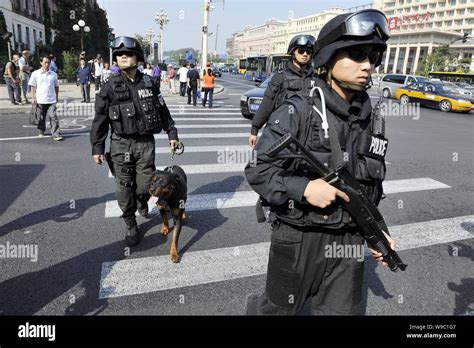 Chinese special policemen and their police dogs patrol the ChangAn Avenue in Beijing, China ...