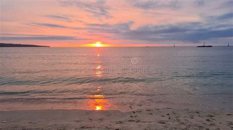 Sunset at Jimbaran beach stock image. Image of cloud - 268948647