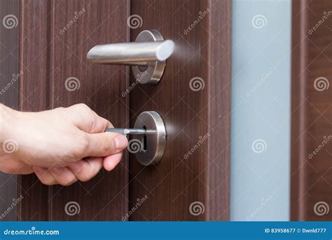 Hand unlocking house door stock image. Image of front - 83958677