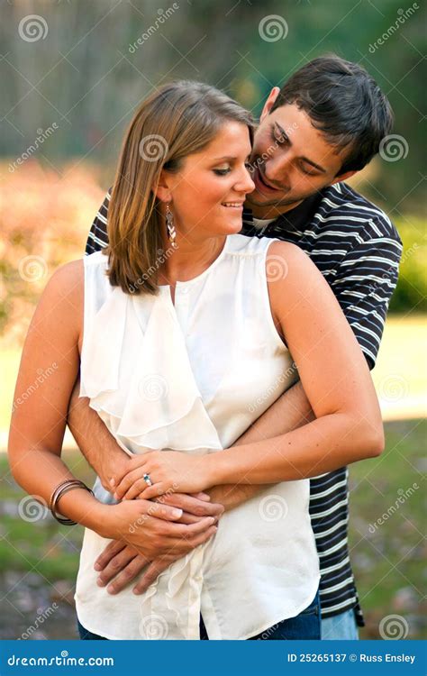 Young Couple In Love Share A Warm Embrace Stock Image - Image: 25265137