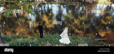 Beautiful wedding couple posing in forest Stock Photo - Alamy