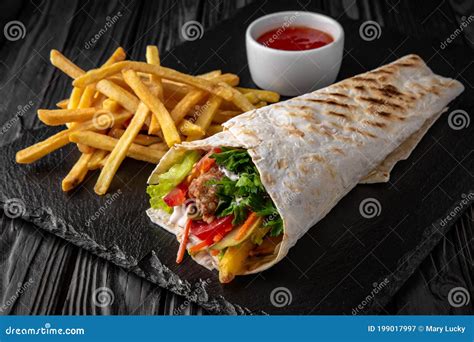 A Delicious Doner Donair Kebab Wrap with Meat, Lettuce, Tomato, Red ...