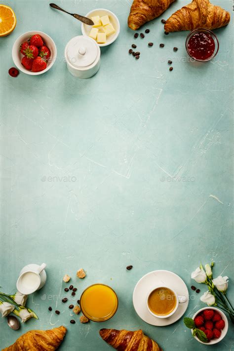 Continental breakfast on blue background captured from above Stock Photo by klenova