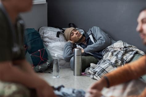 Premium Photo | Man sleeping on floor at refugee shelter