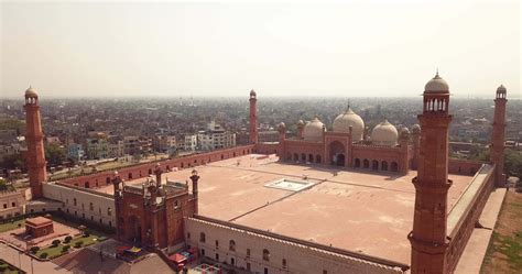 Badshahi Mosque main courtyard with the Minarets in carved red ...