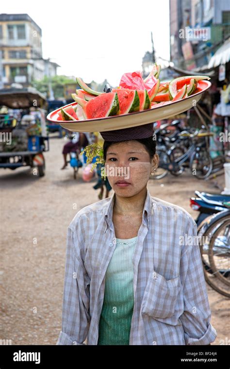 Woman with basket on her head selling food, Yangoon, Myanmar Stock Photo - Alamy